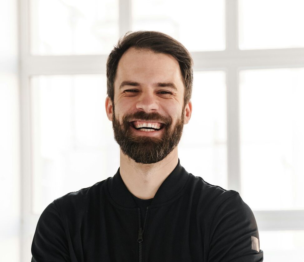 Smiling young brunette white man in sportswear